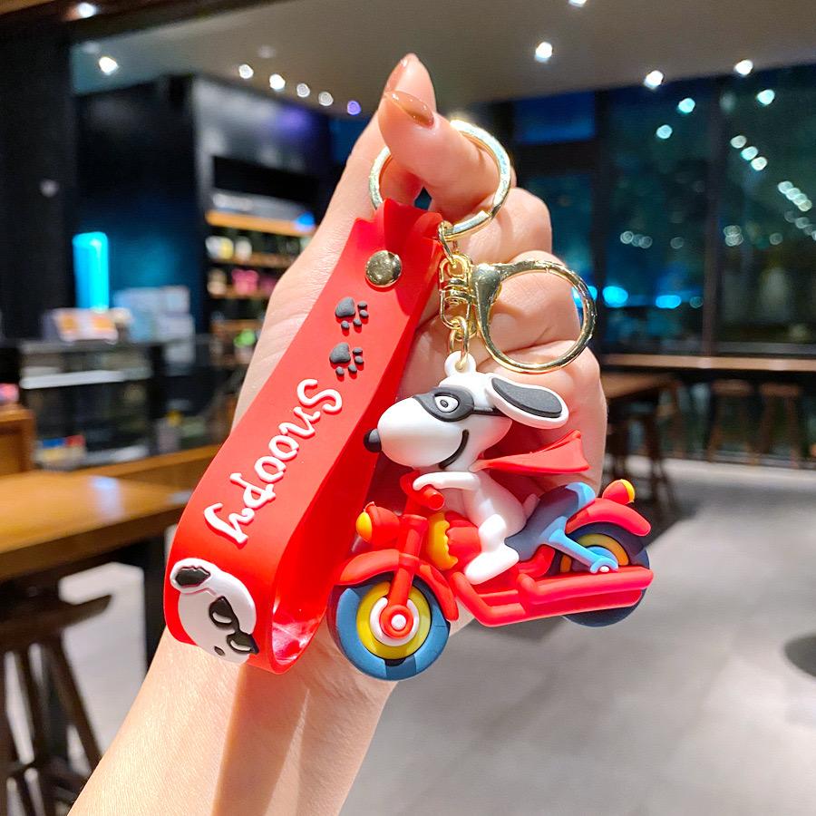 Snoopy on bike rubber keychain